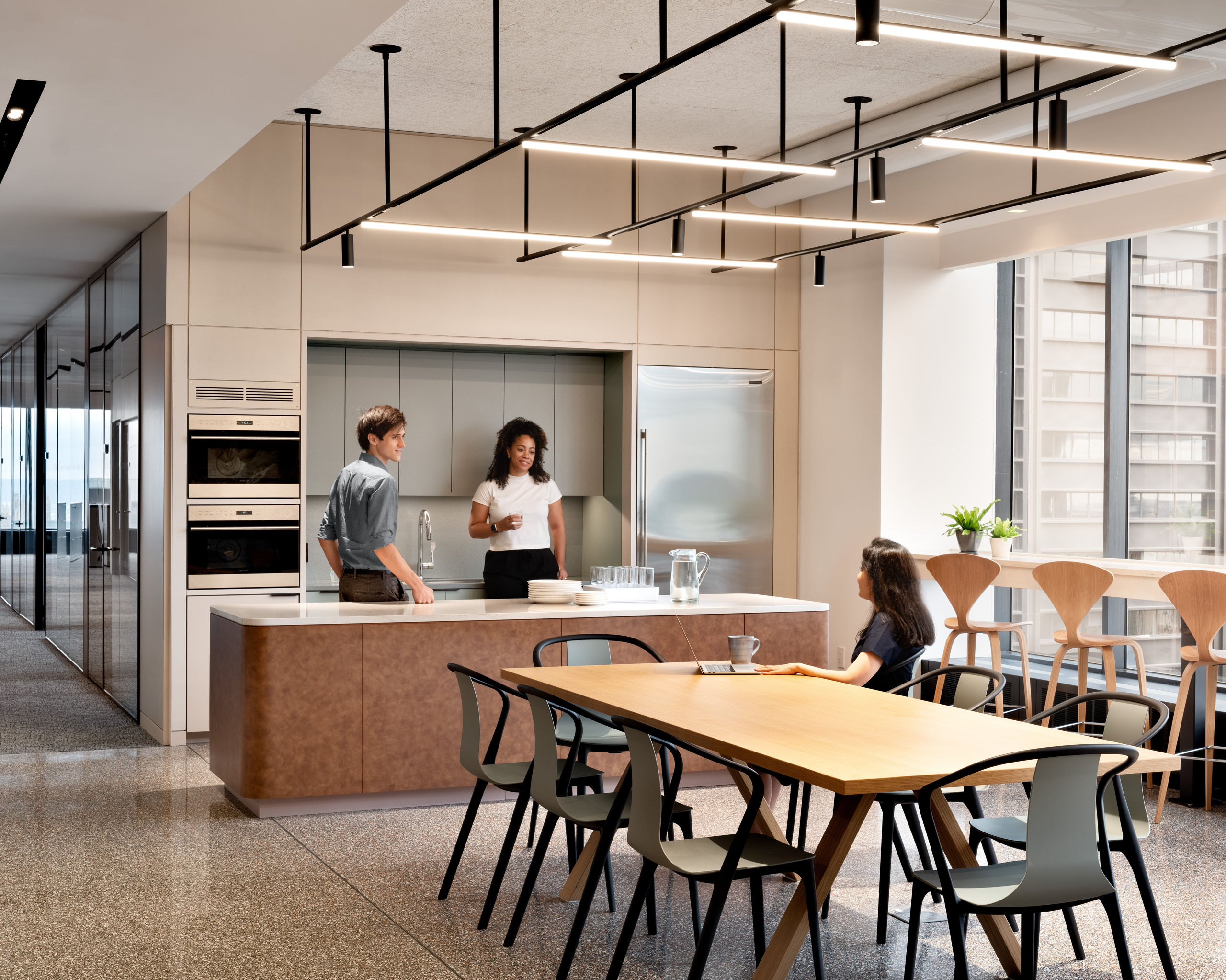 Wallace Foundation kitchen with two people at counter and one person at table