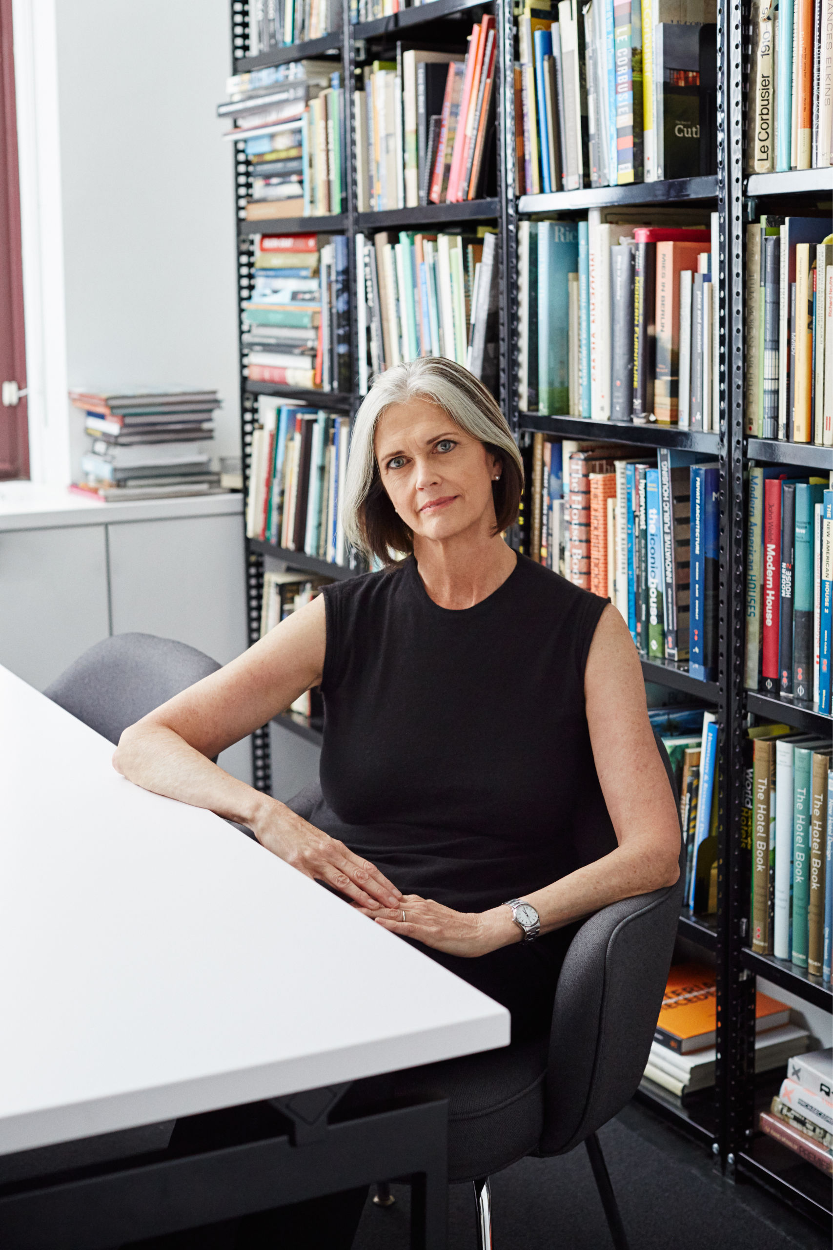 Deborah Berke sitting at table with books