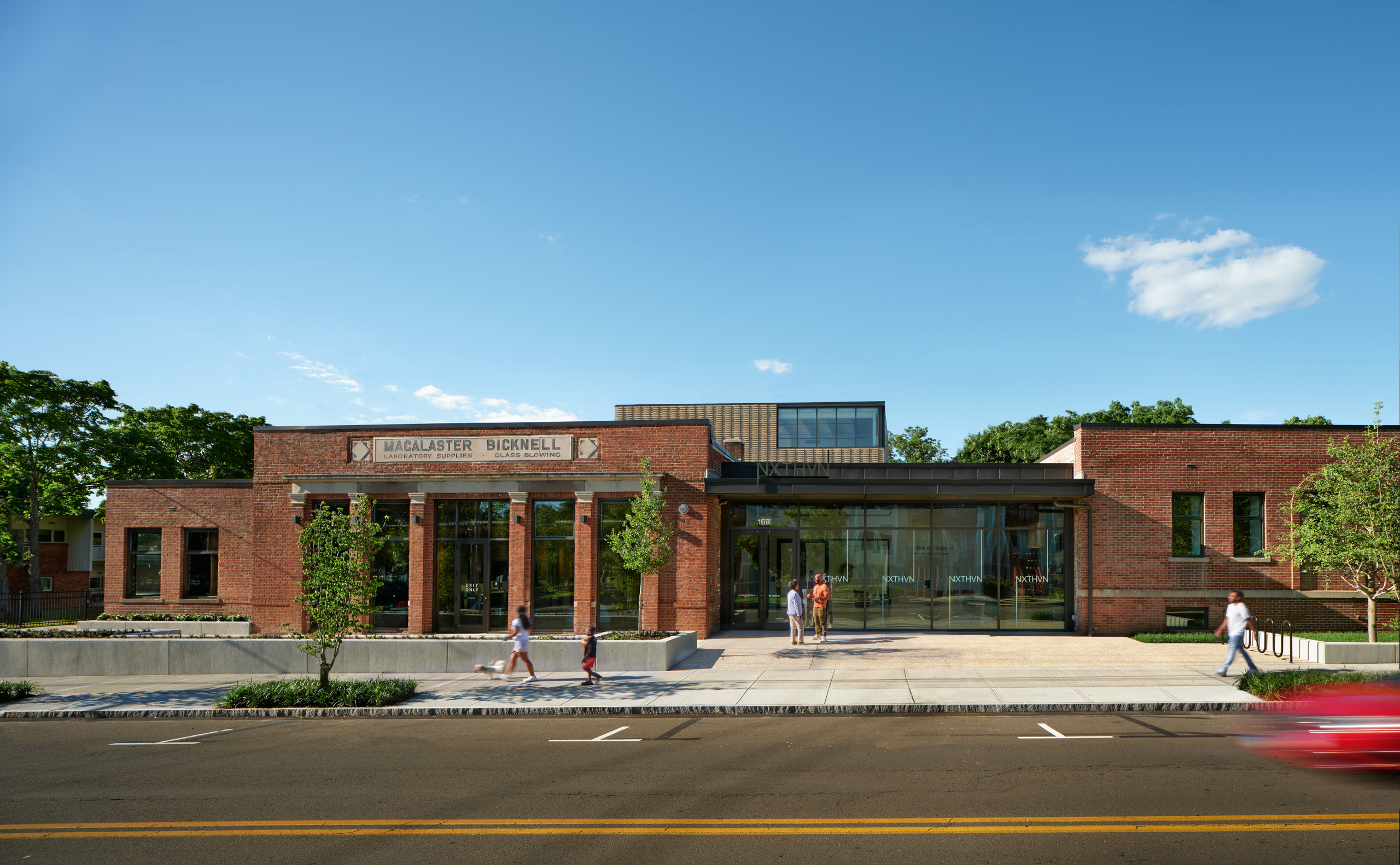 NXTHVN; two former factories joined by new, all glass entrance, with brick addition in the back.